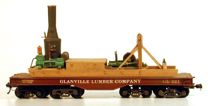 4-truck heavy-duty flatcar carrying log skidder
