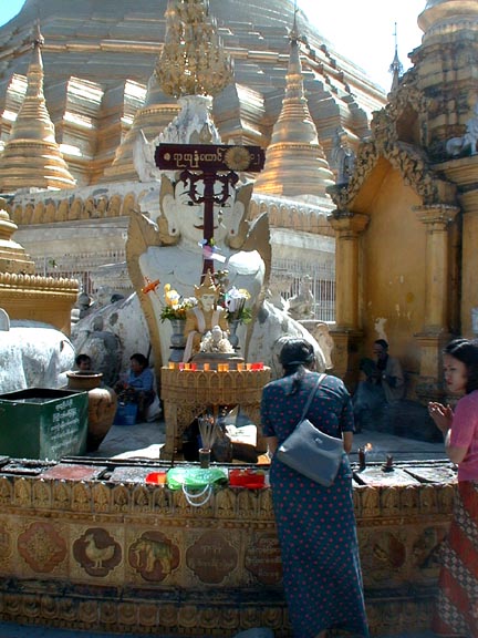 A worshipper at the altar outside a stupa