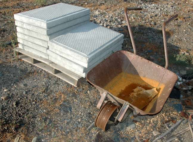 Offset-handled railway wheelbarrow and pile of concrete tiles,  Pocinho, along the Douro River, Portugal
