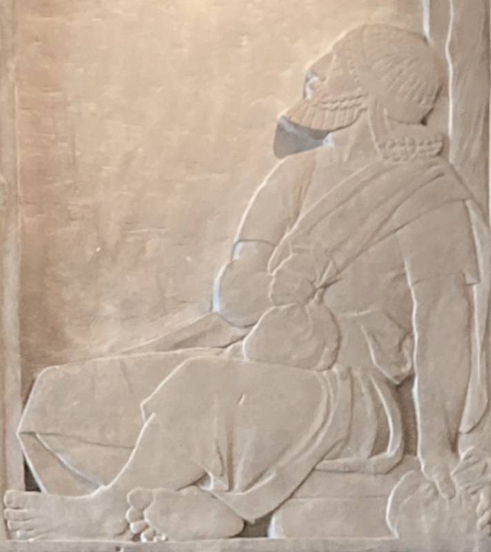 The steward, sitting on the right, with his moneybags
